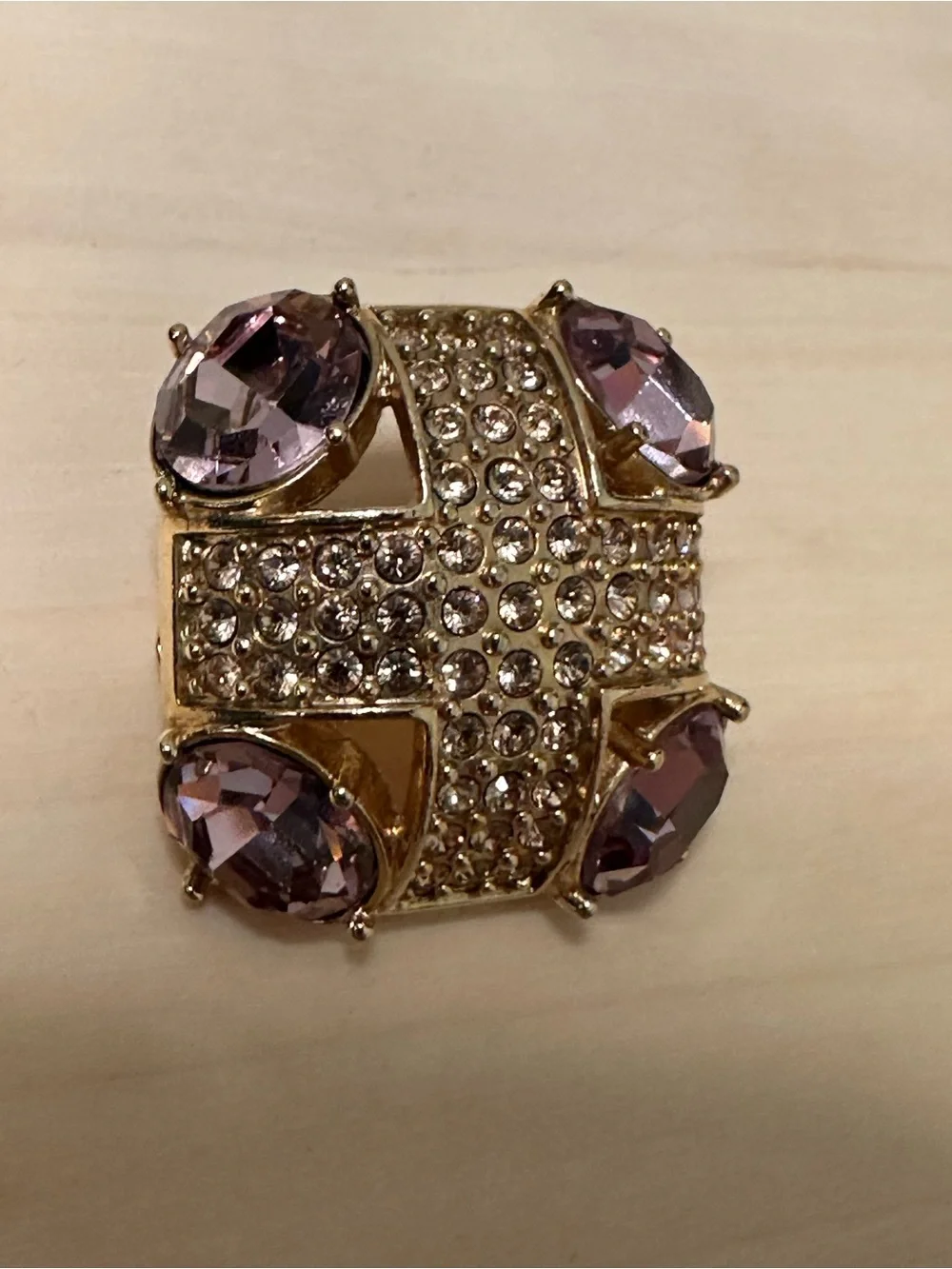 Monet gold-tone brooch with an abstract geometric design with purple stones